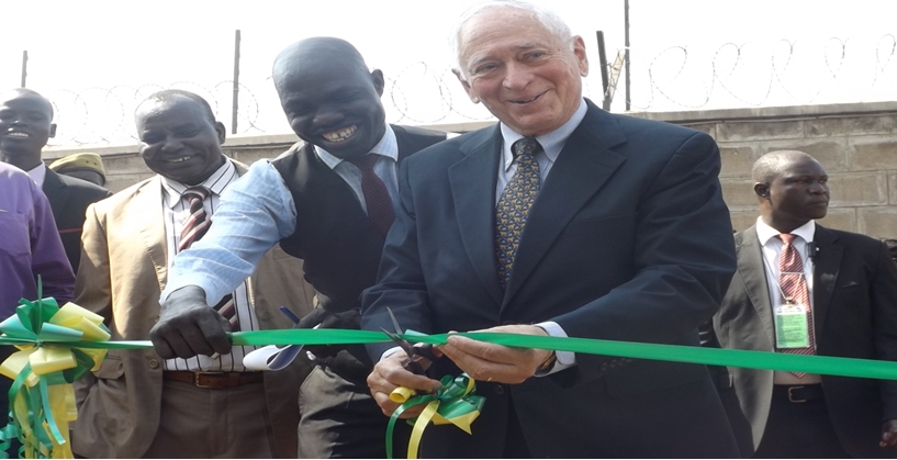 Ambassador Charles Twining (right), Eye Media CEO Stephen Omiri (middle), and Mark Akio (left), Information Minister for Eastern Equitoria state, join in cutting the ribbon to mark the launch of the partnership to expand radio coverage in the country.